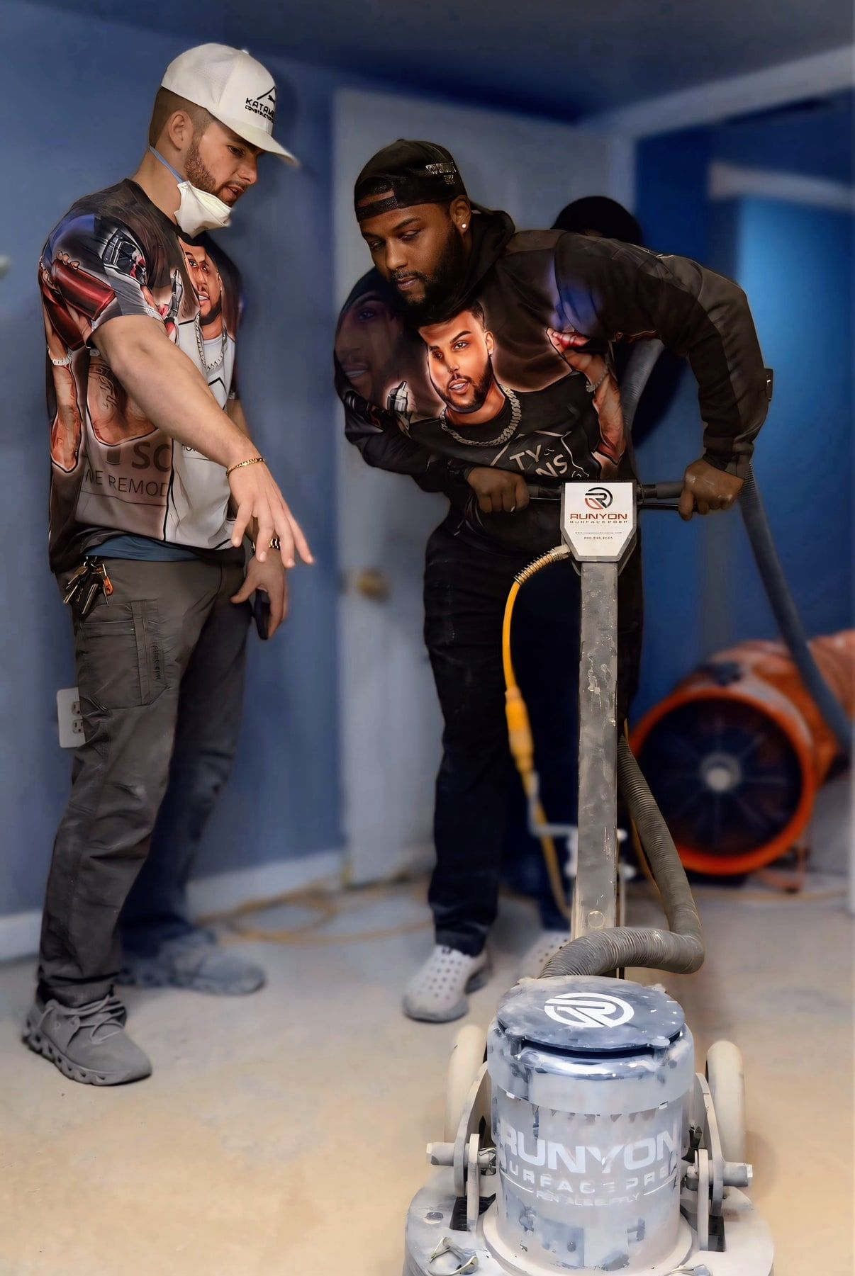 Chris, the owner, on the left, on a job site beside a planetary floor grinder on bare concrete.